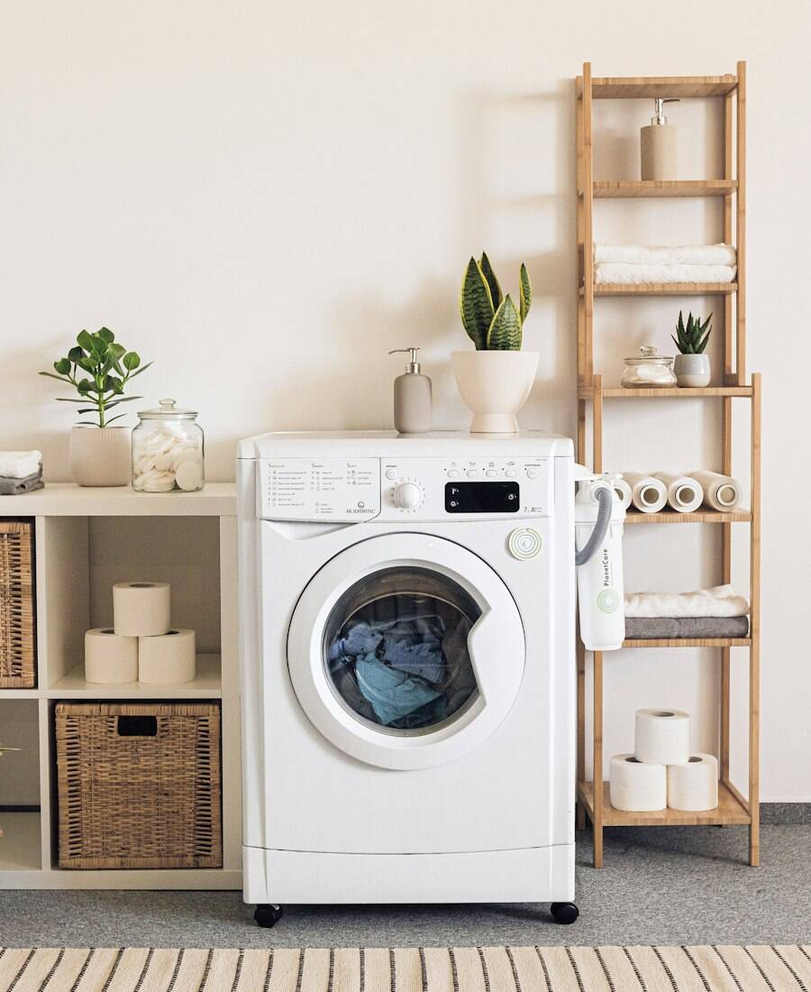 A tidy laundry room with a washer, dryer and folded towels.